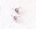 Load image into Gallery viewer, a pair of earrings with a unique design, resting on a white surface.
