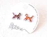 Load image into Gallery viewer, a pair of earrings in the shape of cats, with the packaging for the earrings featuring the brand name &#39;Poptone&#39; and the description of the earrings as &quot;handmade jewelry for the vibrantly quirky&quot;.
