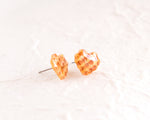 Load image into Gallery viewer, a pair of orange and white checkered earrings
