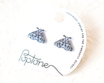 Load image into Gallery viewer, A pair of earrings with a butterfly design, presented on a white background with a black and white text label.
