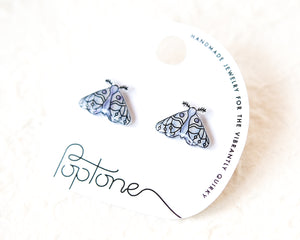 A pair of earrings with a butterfly design, presented on a white background with a black and white text label.