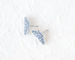 Load image into Gallery viewer, A pair of blue butterfly-shaped earrings with intricate designs on a white background.
