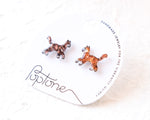 Load image into Gallery viewer, a pair of earrings, each featuring a cat design, displayed on a white label with text.
