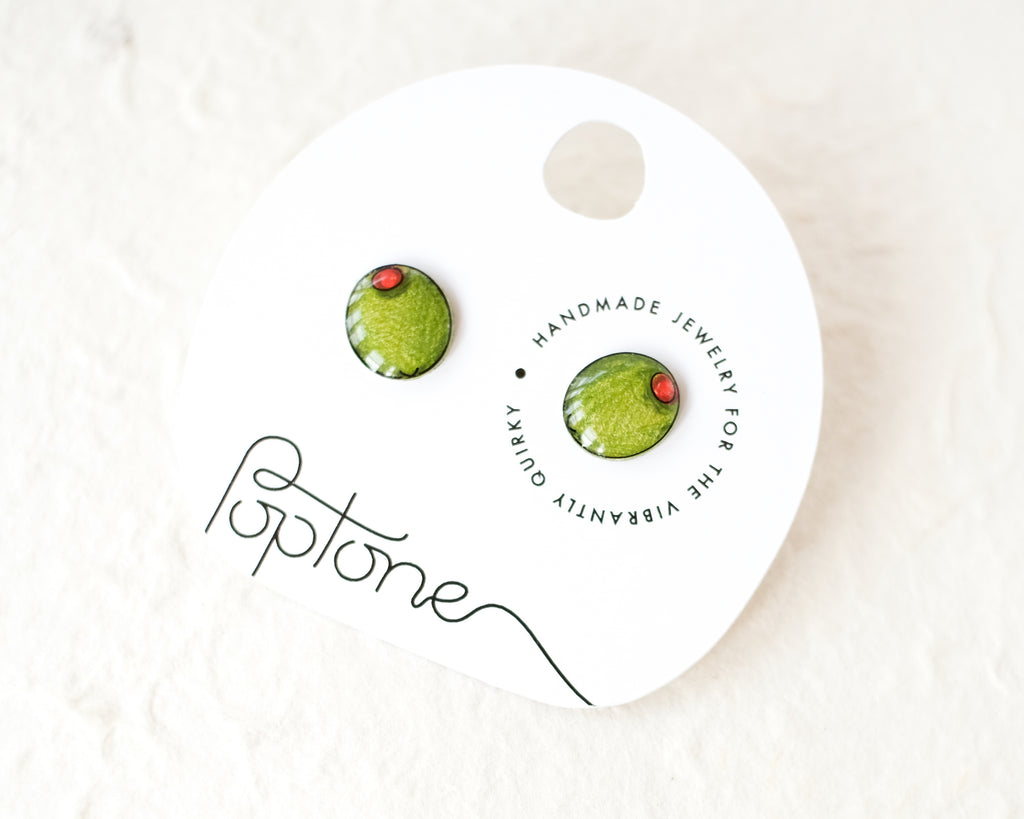 a pair of green and red earrings on a white background