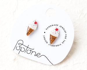 a pair of ice cream earrings on a white background