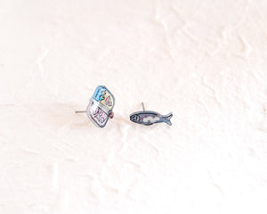 a pair of fish pins sitting on top of a white surface