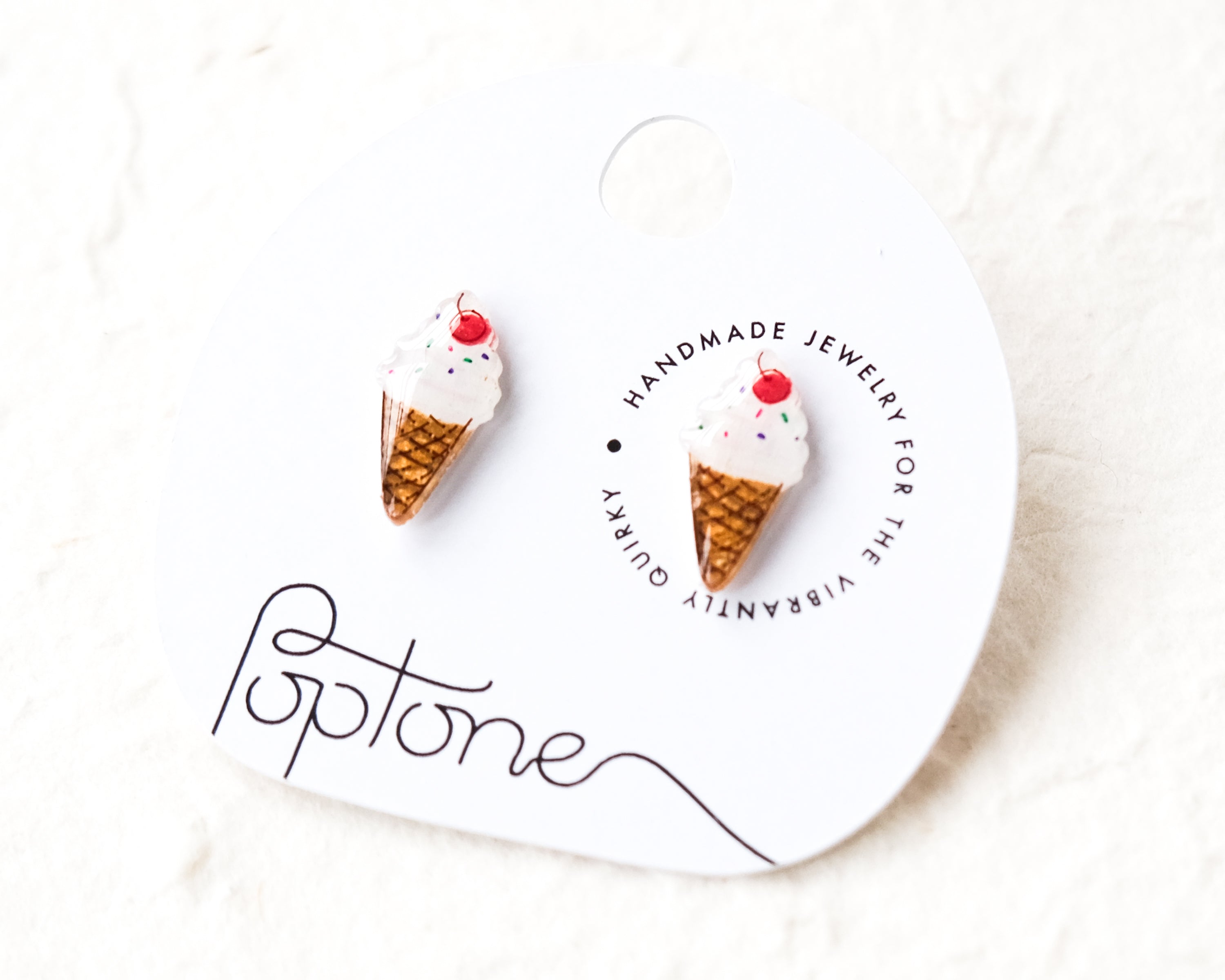 a pair of ice cream cone earrings on a card