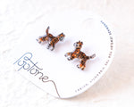 Load image into Gallery viewer, A pair of earrings in the shape of small cats, with the brand name &quot;Poptone&quot; written on the packaging.
