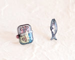 Load image into Gallery viewer, a couple of fish shaped magnets sitting on top of a table
