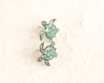 Load image into Gallery viewer, a pair of sea turtle earrings sitting on top of a white surface
