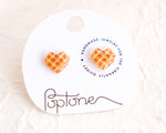 Load image into Gallery viewer, a pair of heart shaped waffle earrings on a white background
