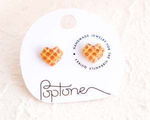 a pair of heart shaped waffle earrings on a white background