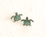 Load image into Gallery viewer, a pair of sea turtle earrings sitting on top of a white surface

