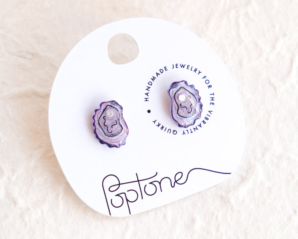 a pair of purple stone studs on a white background