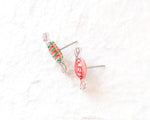Load image into Gallery viewer, Two colorful candy-shaped earrings made of clear plastic and metal are shown against a white background.
