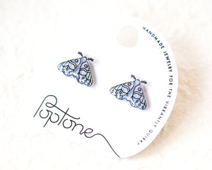 a pair of earrings with a butterfly design, placed on a white background.