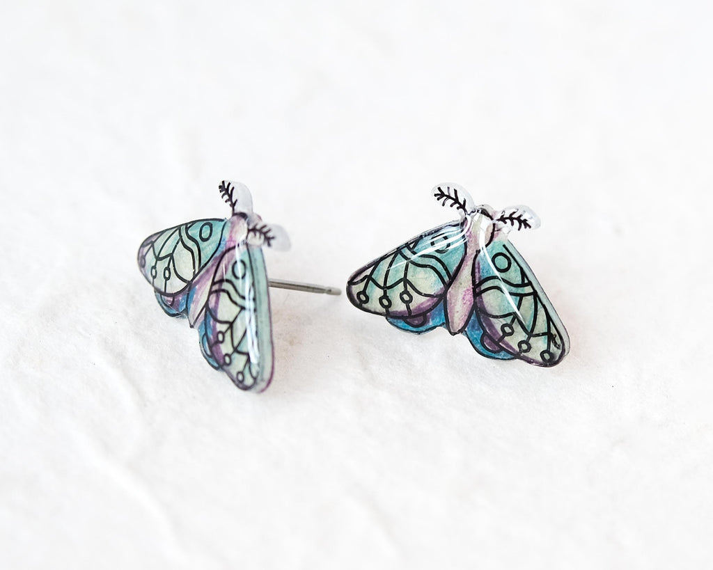 A pair of earrings in the shape of colorful butterflies, with intricate designs and patterns.