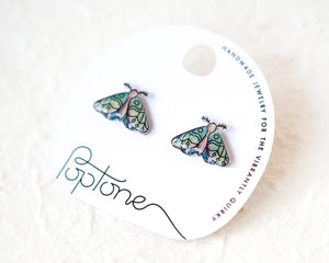 a pair of earrings with a butterfly design, placed on a white background.