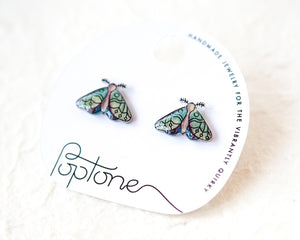 A pair of earrings with butterfly designs, as shown on the packaging.