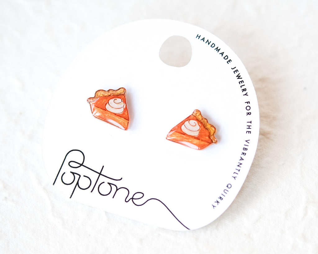 A pair of earrings shaped like slices of pie, with a label that reads "Handmade Jewelry for the Vibrantly Quirky"