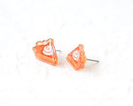Load image into Gallery viewer, A pair of small, orange-colored earrings shaped like slices of pie or cake, with a white swirl design on the surface.
