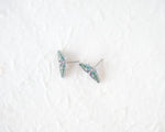Load image into Gallery viewer, A pair of earrings with butterfly designs on a white background.
