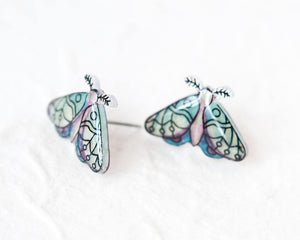 two colorful butterfly-shaped earrings with intricate designs on their wings.