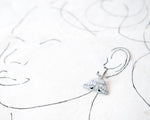 Load image into Gallery viewer, White and Silver Elegant Moth Earrings on Silver Hinged 12 mm Huggie Hoops
