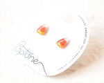 Load image into Gallery viewer, a pair of earrings made of candy, specifically orange and yellow corn candy, placed on a white background.
