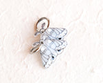 Load image into Gallery viewer, A silver charm in the shape of a butterfly with intricate wing patterns.
