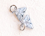 Load image into Gallery viewer, two silver butterfly-shaped charms with intricate designs, hanging from a circular hook.
