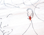 Load image into Gallery viewer, a red lobster earring on a person&#39;s ear, with a drawing of a face in the background.
