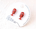 Load image into Gallery viewer, a pair of red lobster earrings displayed on a white circular card with text and graphics.
